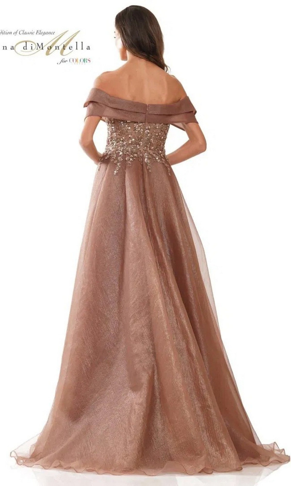 Woman wearing the Rina Di Montella RD2816 long formal dress, a floor-length shimmery brown gown with floral-embellished bodice and delicate tulle overskirt, seen from the back.